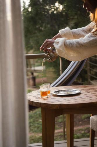 a person pouring a glass of beer on a table at Radisson Blu Resort Taghazout Bay Surf Village in Taghazout