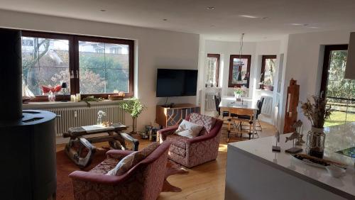 a living room with two chairs and a table at Wolke 1 in Seebruck
