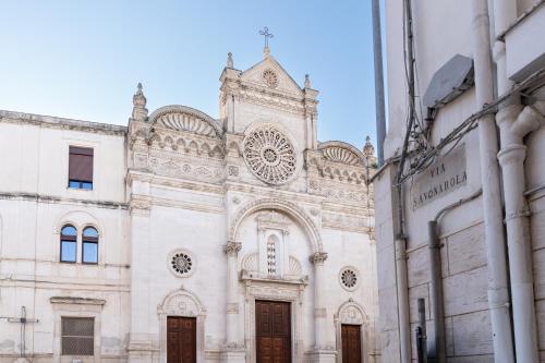 an old church with a clock tower on a building at Dimora Berardino in Triggiano