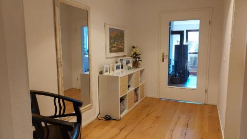 a living room with a chair and a mirror at Wolke 1 in Seebruck