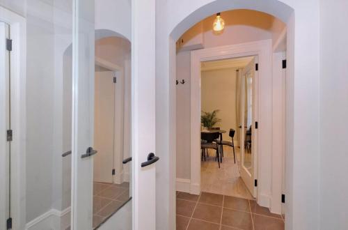 a hallway with white walls and a dining room with a table at Granton Place in Aberdeen