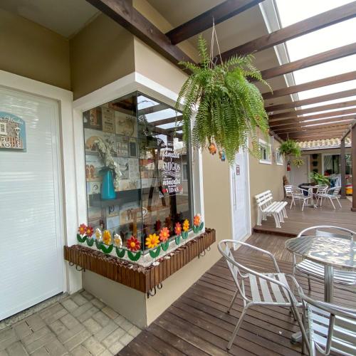 a shop with a flower display on a deck at Pousada Rota dos Mares in Penha