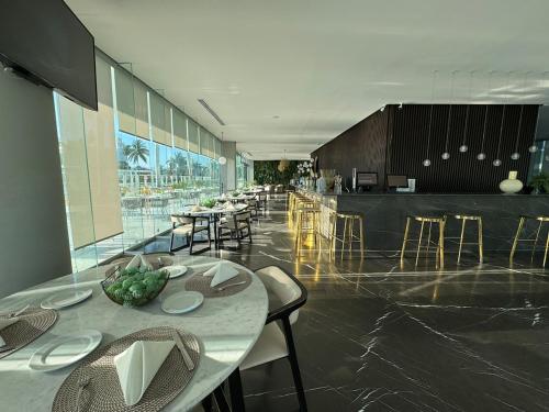 a dining room with tables and chairs in a building at Departamento Arrecife Beach, Nuevo Vallarta in Nuevo Vallarta 