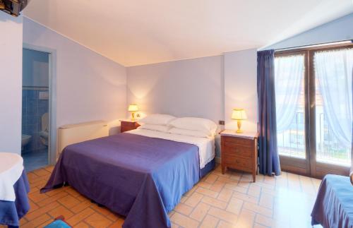 a bedroom with a bed and a large window at Velia Mare in Numana