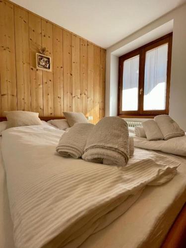 a large bed with two pillows on top of it at Trilo La Rindela in Folgaria