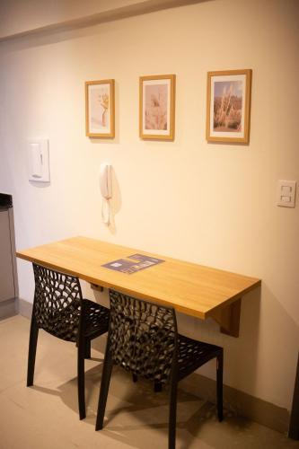 a wooden table with a phone on a wall at Actual - SmartHouse in Uberlândia