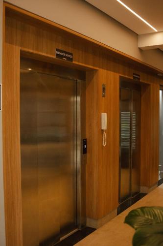 an elevator in a building with a sign on it at Actual - SmartHouse in Uberlândia