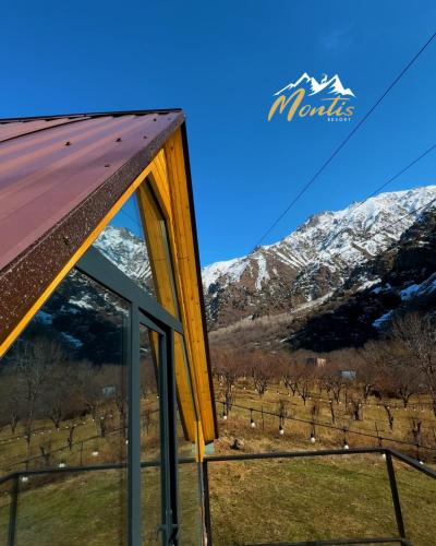 a view of the mountains from the window of a house at Montis Resort in Yeghegis