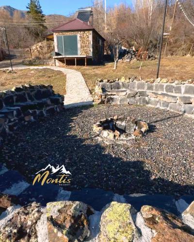 a fire pit in the backyard of a house at Montis Resort in Yeghegis