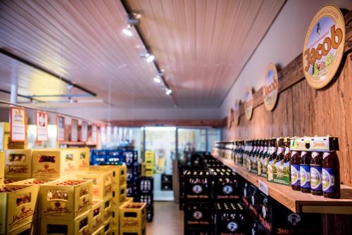 a store aisle with bottles of beer on display at Brauereigasthof Jacob Bodenwöhr in Bodenwöhr