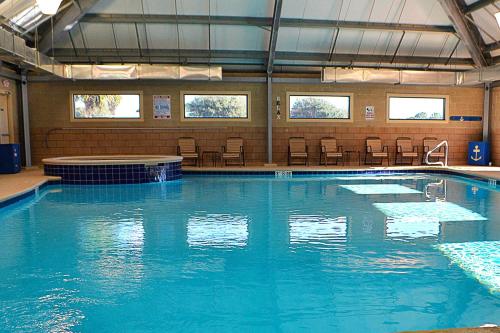 a large swimming pool with blue water in a building at Plantation Dunes #5101 in Gulf Shores