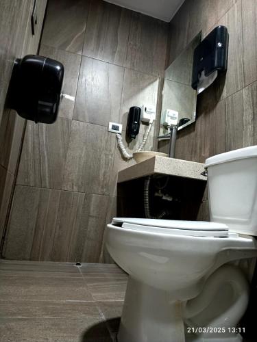 a bathroom with a toilet and a phone at Tepeyac 402 in León