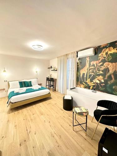 a bedroom with a bed and a painting of giraffes at Luxury Fire Home - Catania in Catania