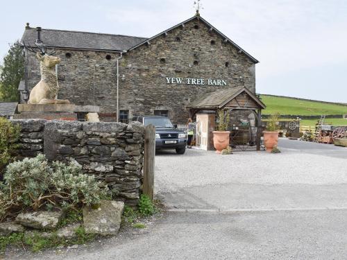 a car parked in front of a stone building at Yew Tree Farm in High Newton