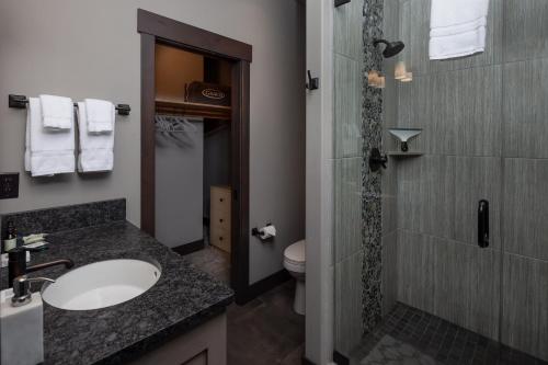 a bathroom with a sink and a toilet and a shower at Lodge at Whitefish Lake in Whitefish