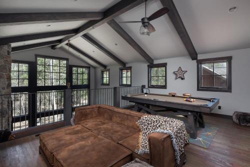 a living room with a couch and a pool table at Lodge at Whitefish Lake in Whitefish