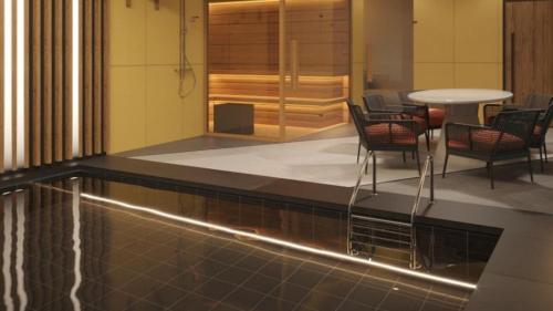a lobby with a pool and chairs and a table at Holiday Inn Tashkent City by IHG in Tashkent