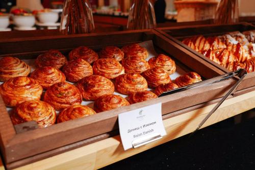 a tray of croissants and other pastries on display at Holiday Inn Tashkent City by IHG in Tashkent