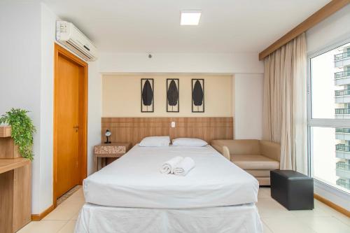 a hotel room with a bed and a chair at BSB STAY Premium Flats Particulares - Saint Moritz in Brasilia