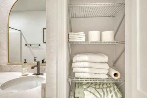 a bathroom with a sink and a bunch of towels at Waterfront Family Vacation , Near Ocean and Mineral Springs, 7 sleeps in Rotonda West