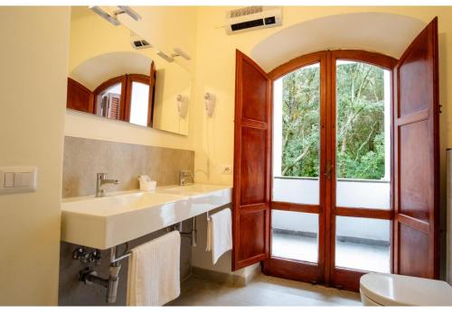 a bathroom with two sinks and a large window at Villa Talia Sweet Rooms B&B in Ischia