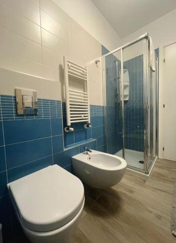 a blue and white bathroom with a toilet and a sink at Sake' Beach in Senigallia