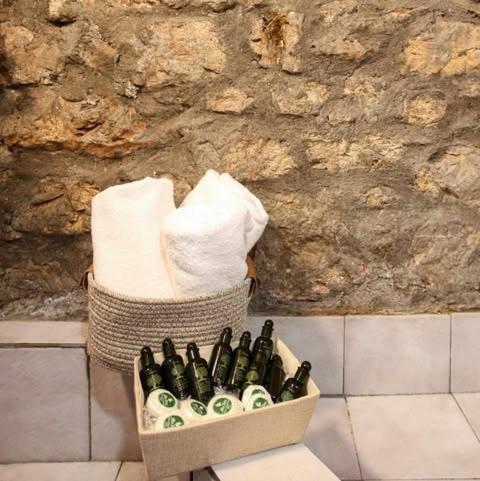 a basket full of bottles of beer and towels at MARIOLATA STONE HOUSE in Lílaia