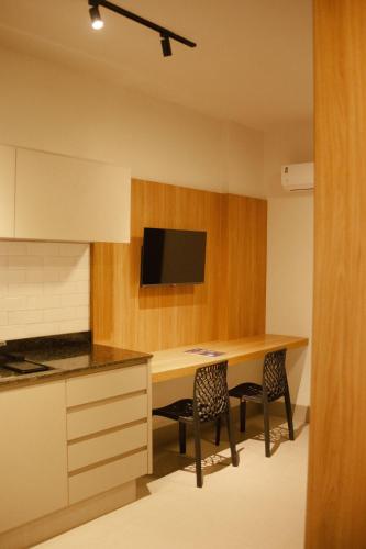 a kitchen with a wooden table and two chairs at Actual - SmartHouse in Uberlândia