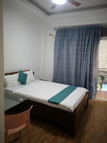 a small bed in a room with a window at Aguada Hills Residence in Puerto Galera