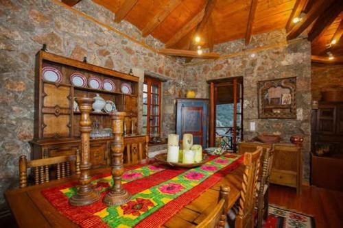 a dining room with a table in a stone room at MARIOLATA STONE HOUSE in Lílaia