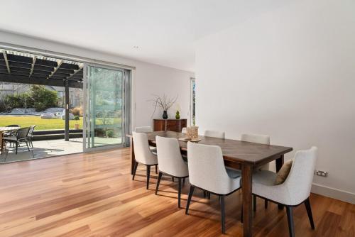 a dining room with a wooden table and chairs at Kinsale- 3 Bedroom Home in Arrowtown