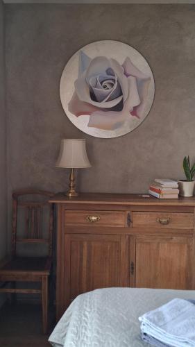 a bedroom with a bed and a table with a lamp at Promenādes apartamenti in Talsi