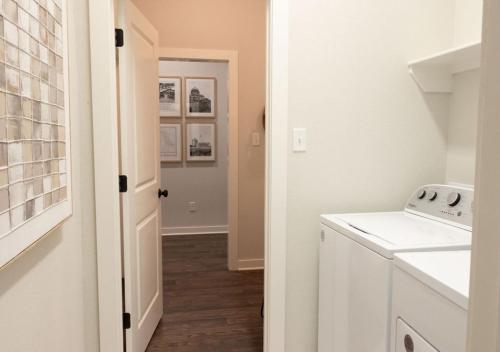 a white laundry room with a washer and dryer at Luxury Home Near Kyle Field & Expo Center in Bryan
