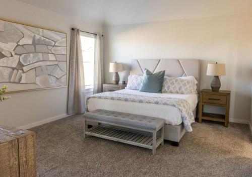 a white bedroom with a bed and a window at Luxury Home Near Kyle Field & Expo Center in Bryan