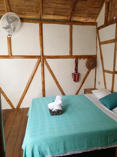 a room with a bed with a towel on it at The Bonito Place in Taganga