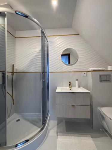 a bathroom with a shower and a sink at Polanki 22 in Łeba