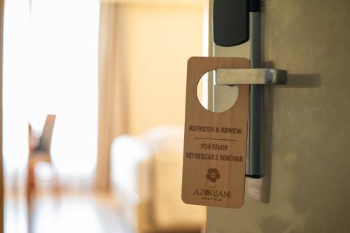 a door opener with a permit on the door at The Azoriani Boutique, Ascend Hotel Collection in Ponta Delgada