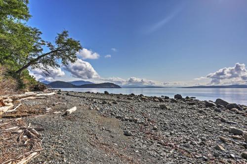 a rocky beach with a tree and the water at TideAway Farm on Private Island! Escape & Indulge Mother Nature! in Anacortes
