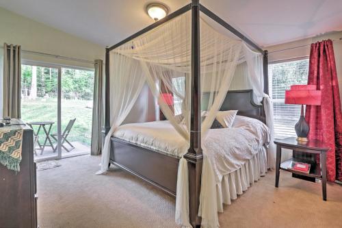 a bedroom with a canopy bed with a window at TideAway Farm on Private Island! Escape & Indulge Mother Nature! in Anacortes