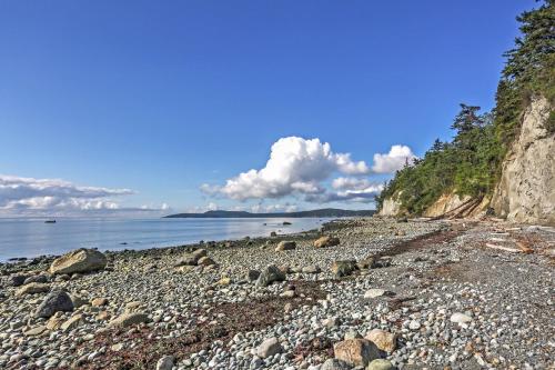 a rocky beach next to the ocean on a sunny day at TideAway Farm on Private Island! Escape & Indulge Mother Nature! in Anacortes