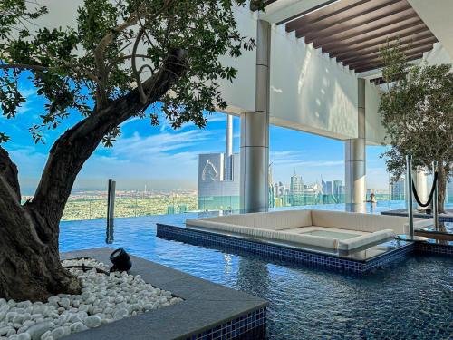 a rendering of a building with a tree and water at PARAMOUNT MIDTOWN RESIDENCES - A Luxury 2 BR Apartment near BURJ KHALIFA and DUBAI MALL in Dubai