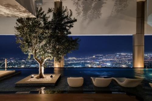 a tree on a table with a view of a city at PARAMOUNT MIDTOWN RESIDENCES - A Luxury 2 BR Apartment near BURJ KHALIFA and DUBAI MALL in Dubai