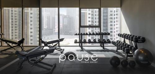 a gym with cardio equipment in a large window at PARAMOUNT MIDTOWN RESIDENCES - A Luxury 2 BR Apartment near BURJ KHALIFA and DUBAI MALL in Dubai