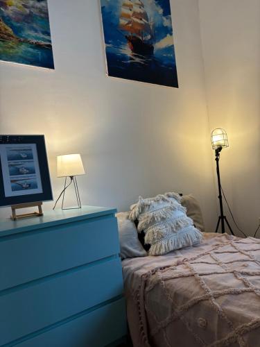 a bedroom with a bed and a dresser with a television at Art of Sopot in Sopot
