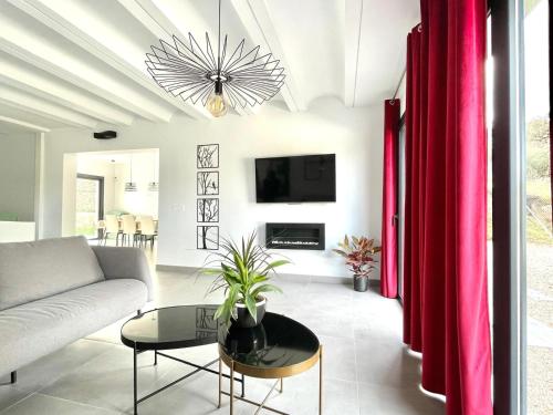 a living room with a couch and a table at Villa Las Encinas in Guillena