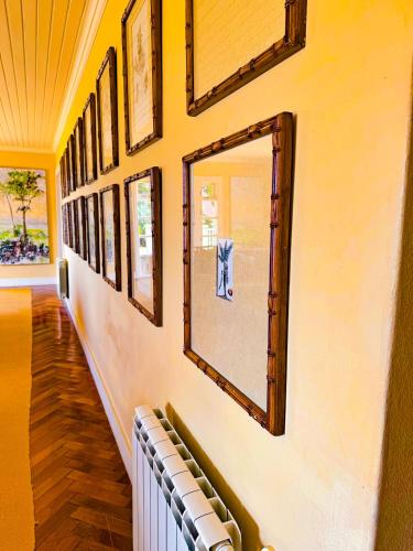 a hallway with a row of mirrors on a wall at Villa Coração Guesthouse by Concavus in Monte Verde