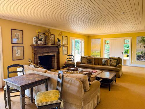 a living room with a couch and a fireplace at Villa Coração Guesthouse by Concavus in Monte Verde