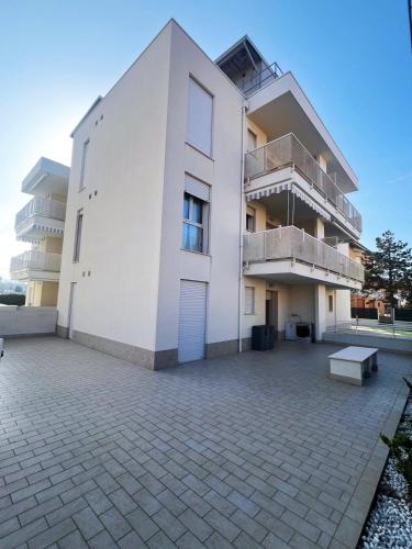 a white building with a bench in front of it at Sake' Beach in Senigallia