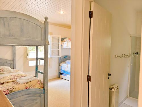 a bedroom with a bunk bed and a doorway at Villa Coração Guesthouse by Concavus in Monte Verde