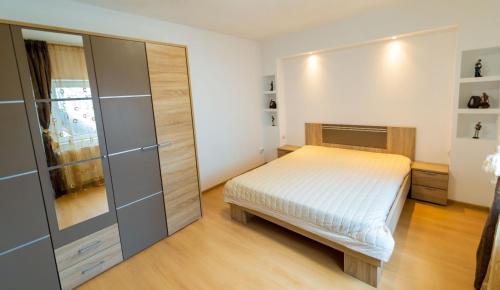a small bedroom with a bed and a closet at Casa Bibi in 2 Mai
